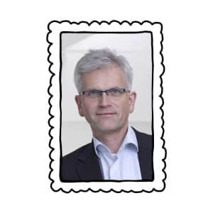 Foto vom Herrn Peham in einem gezeichneten Bilderrahmen.